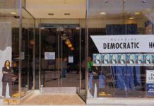 Storefront of Westside Democratic Headquarters with signs.