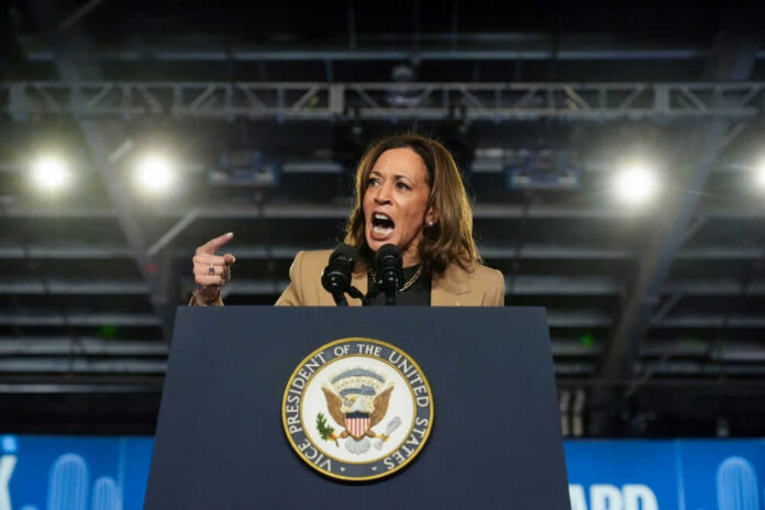 Person speaking passionately at a podium with microphones.