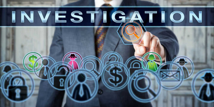 Businessman pointing at investigation themed icons