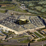 Aerial view of the Pentagon building surrounded by roads and greenery