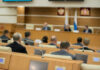 Socialist Boss, Million-Dollar Pad? Audience attending a government meeting in a conference room