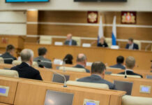 Audience attending a government meeting in a conference room