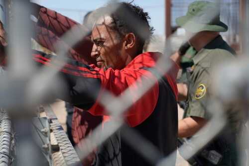 El,Paso,,Tx,Usa,May,10,,2023,(picture,Taken,Through Individual at a border fence with law enforcement officers nearby