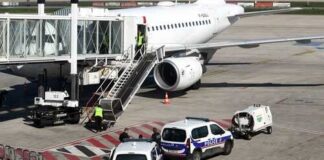 Police vehicles near an airplane at an airport