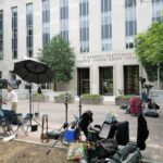 CNN Clash: ‘Murder’ Claim Meets Evidence Media equipment and journalists outside a courthouse
