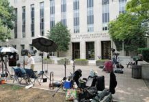 CNN Clash: ‘Murder’ Claim Meets Evidence Media equipment and journalists outside a courthouse