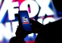 Fox Star Warns: GOP Collapse Looming A person holding a smartphone displaying the Fox News logo against a colorful background