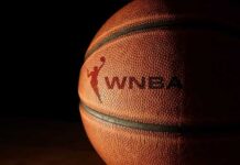 Close-up of a basketball with a logo in low light