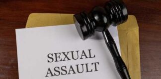 A court gavel resting on a document labeled 'SEXUAL ASSAULT'