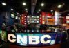 Interior of a CNBC news studio with multiple screens and a modern design