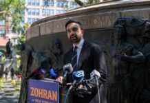 A man giving a speech at a podium in a city park