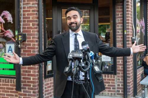 Democratic,New,York,City,Mayoral,Candidate,Zohran,Mamdani,Appears,At Man in a suit speaking at a press conference with microphones in front of him