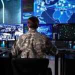 Mystery Spy Planes Stalk US Border Military personnel monitoring multiple screens in a command center