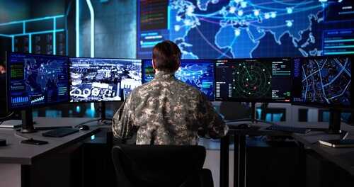 In,The,Government,Military,Control,Center,,A,Senior,Soldier,Monitors Military personnel monitoring multiple screens in a command center