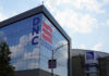 Building with DNC 2024 sign reflected in glass.