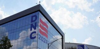 Building with DNC 2024 sign reflected in glass.