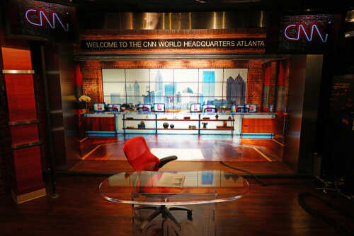 Interior of CNN World Headquarters studio with a red chair and glass desk