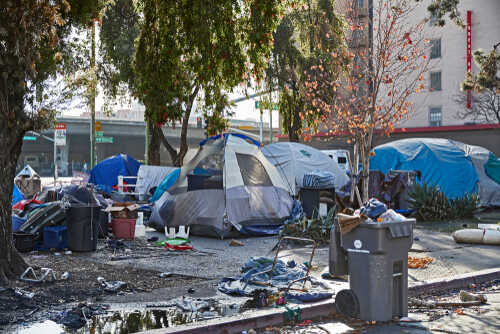 Oakland,,California,,Usa,-,December,16,,2018:,Homeless,Camp,At A homeless encampment with tents and scattered debris in an urban setting