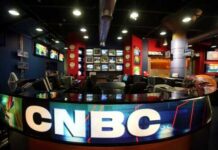 Interior of a CNBC news studio with multiple screens and a modern design
