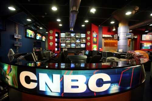 Interior of a CNBC news studio with multiple screens and a modern design
