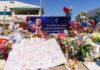 A memorial with flowers, balloons, and a tribute banner honoring someone named Charlie
