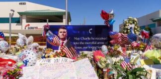 A memorial with flowers, balloons, and a tribute banner honoring someone named Charlie