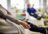 Patient receiving IV therapy in a hospital room