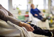 Patient receiving IV therapy in a hospital room