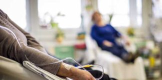 Patient receiving IV therapy in a hospital room