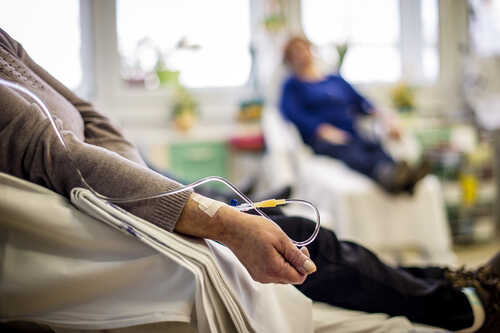 Patient receiving IV therapy in a hospital room