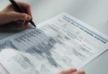 A person filling out an official ballot for a general election