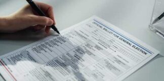 A person filling out an official ballot for a general election