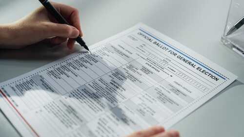 Close,Up,Footage,Of,A,Person,Filling,Out,A,Paper A person filling out an official ballot for a general election